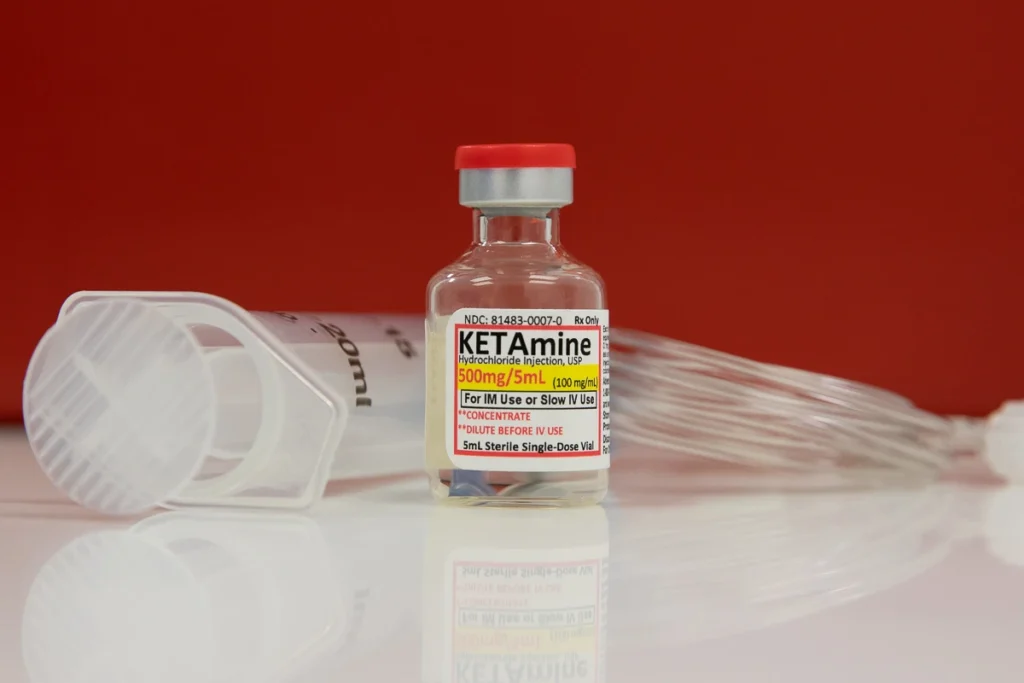 2025-03 Wells Medicine - Ket - C17A5963 copy Vial of ketamine next to syringe and IV tubing